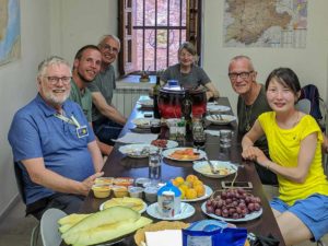 Hospitalero Peter Millington, far left, shares an evening meal with pilgrims at Albergue de Peregrino de Zamora,